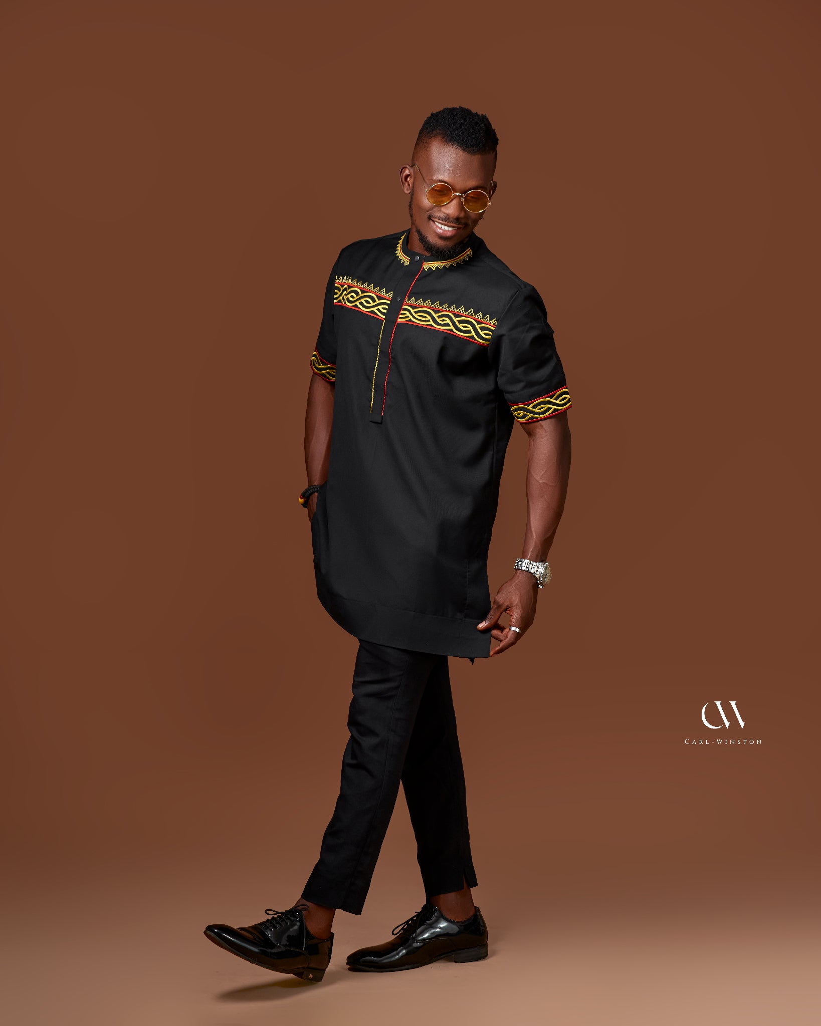 Carl-Winston black traditional tunic with bold yellow and red embroidery stylish men blend of African heritage and modern elegance