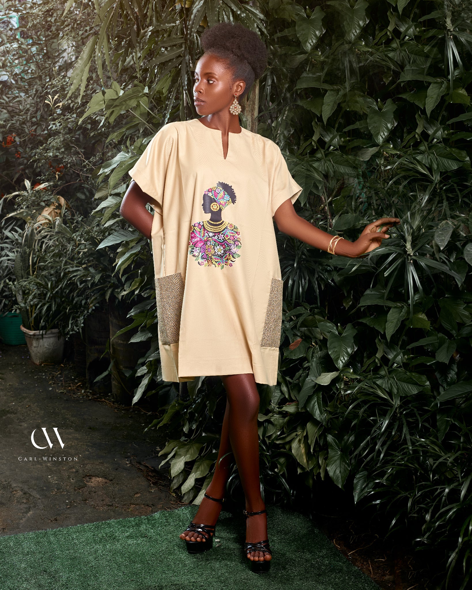 Carl-Winston beige African-inspired dress with a vibrant, colorful silhouette print, celebrating cultural heritage and elegance. Perfect for a stylish and comfortable look with deep pockets, adorned with matching accessories.