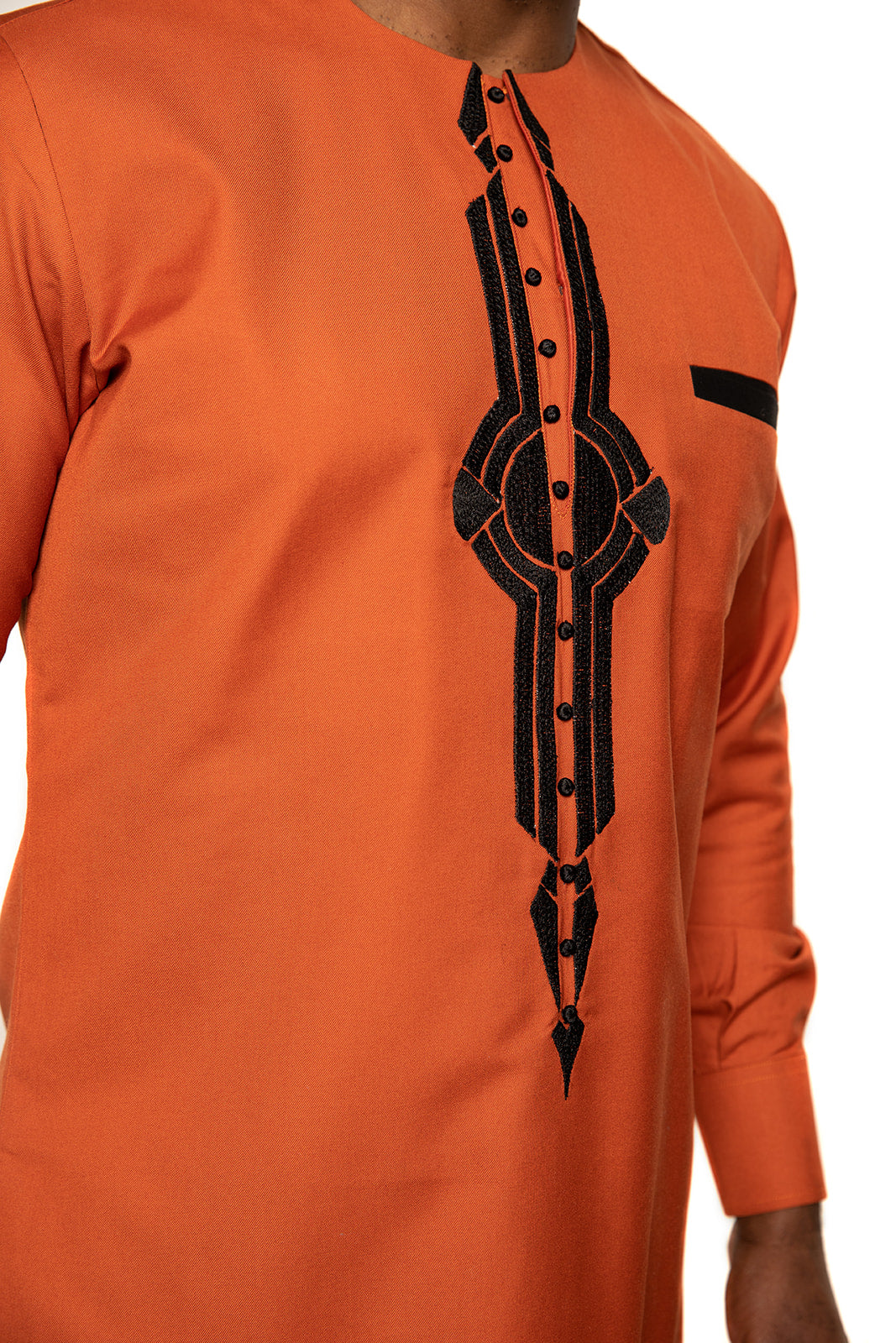 Bold orange African shirt with detailed black embroidery and button design. Ideal for men seeking modern yet cultural attire
