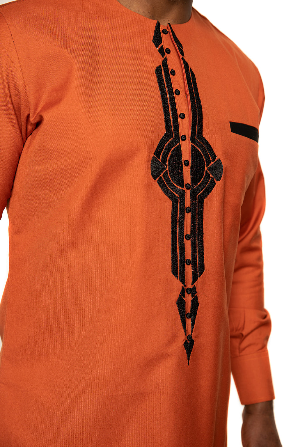 Bold orange African shirt with detailed black embroidery and button design. Ideal for men seeking modern yet cultural attire
