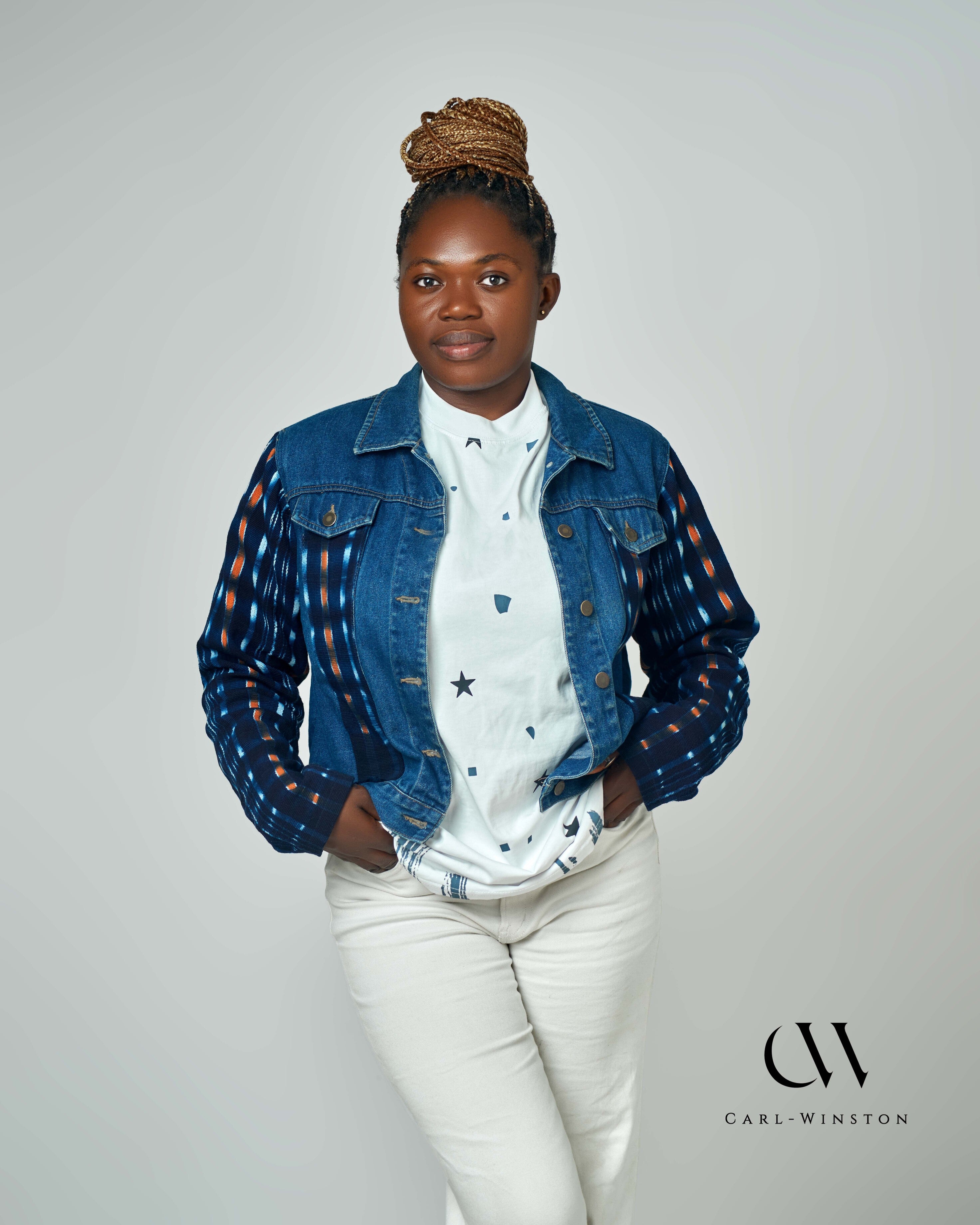 A stylish denim jacket with bold Kente cloth accents on the sleeves, blending contemporary fashion with traditional African heritage. Designed by Carl-Winston, this unique piece features deep indigo and orange hues, symbolizing wisdom and prosperity. Perfect for casual and smart-casual styling