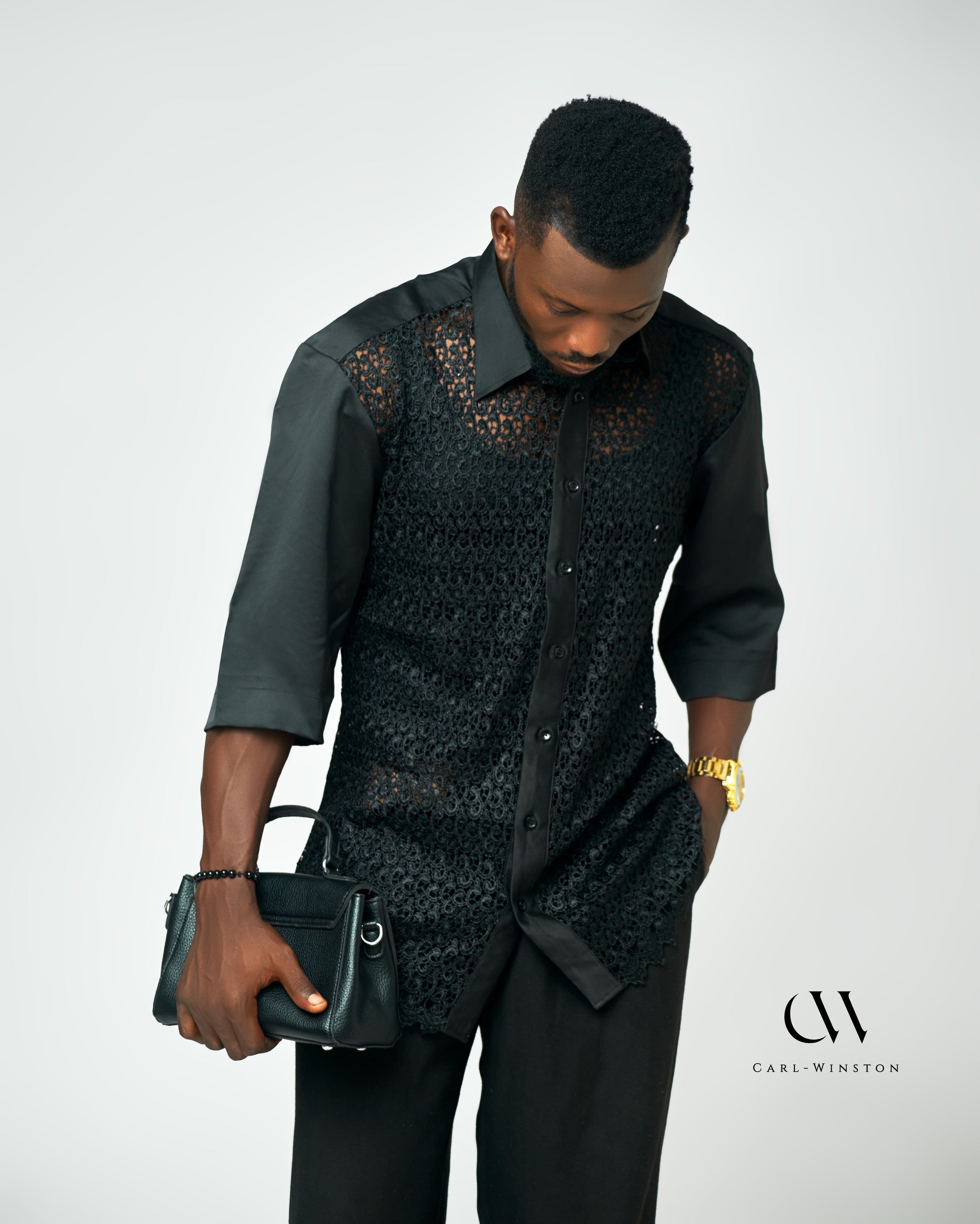 A modern black lace button-up shirt with structured satin sleeves, designed for men who appreciate luxury and refined style.