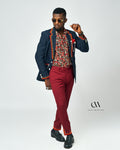 A paisley-print men’s shirt in vibrant colors, styled with a navy blazer and maroon pants for a bold and sophisticated look by Carl-Winston.