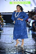 The Royal Indigo Heritage Dress is a tribute to African craftsmanship—crafted from indigo-dyed fabric and styled with cultural cowrie accents. Worn at Ankara Fest, this look celebrates strength, beauty, and authenticity. 