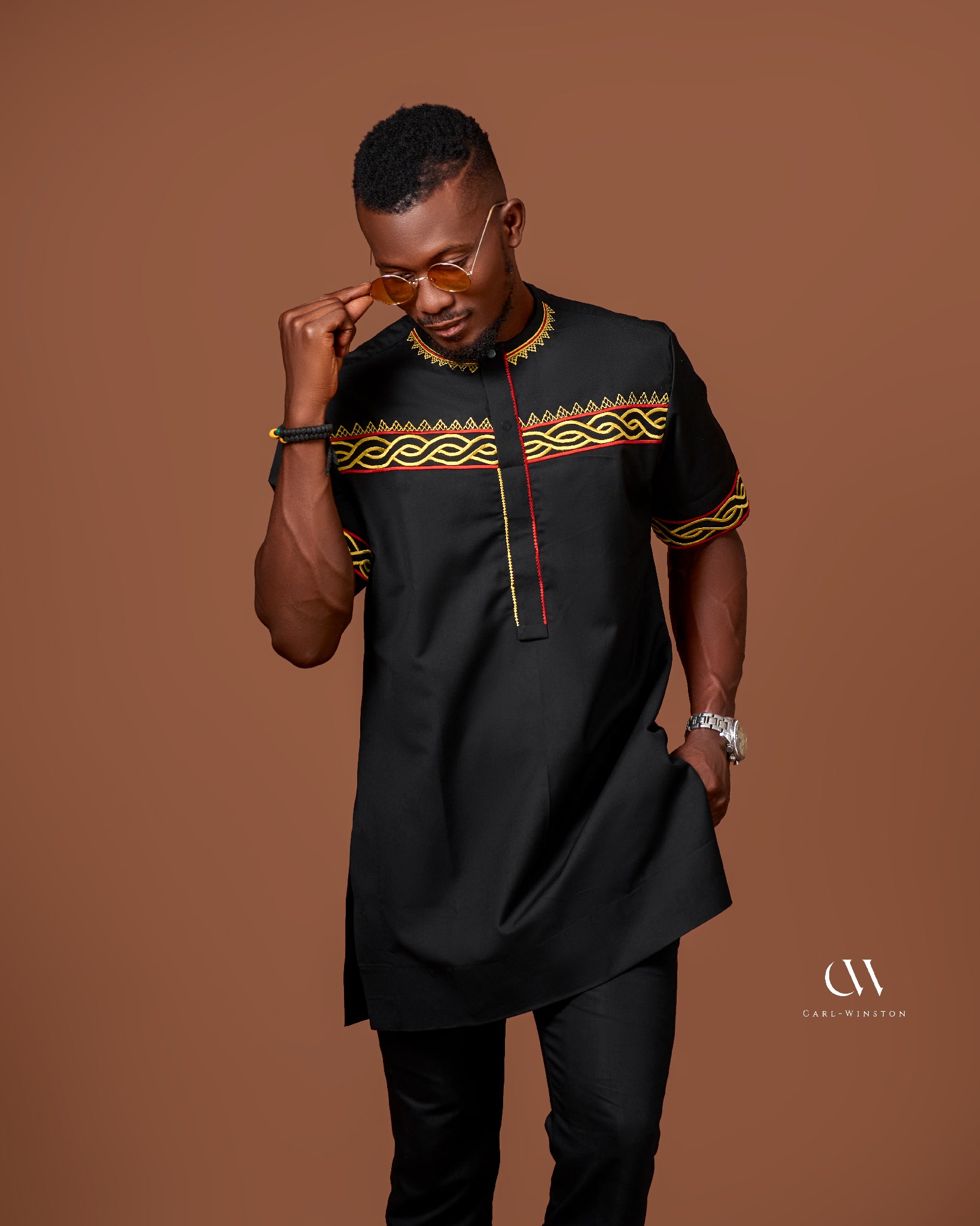 Black traditional tunic with bold yellow and red embroidery African heritage modern elegance Carl-Winston 