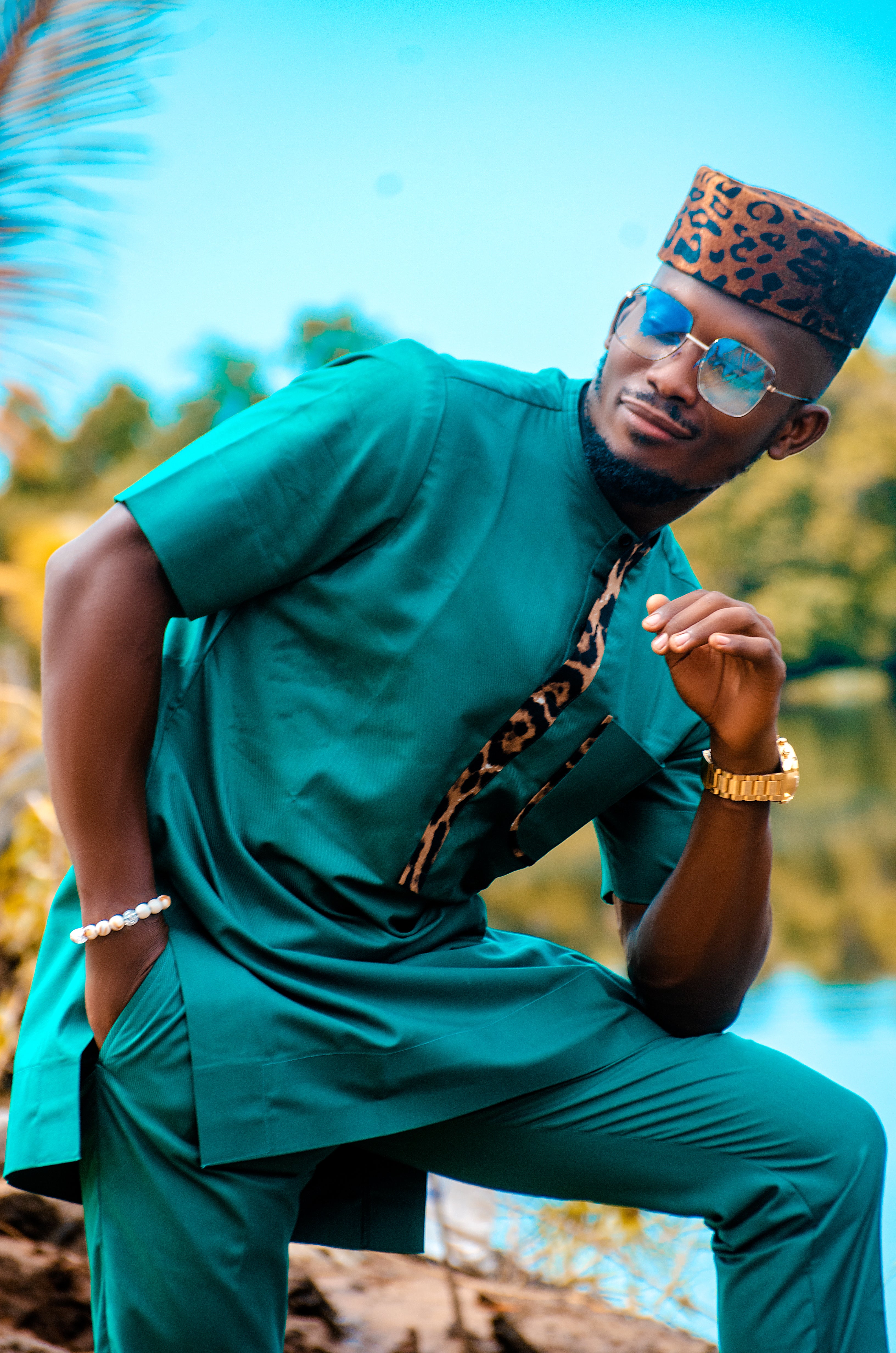 Stylish Black Man Wearing Traditional Green African Outfit with Leopard Print Accent and Leopard Print Hat Modern and Cultural Fashion Statements Carl-Winston